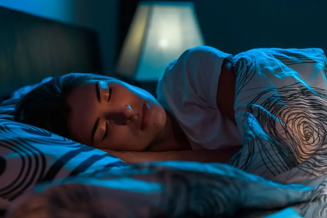 young-woman-sleeping-bed-dark-bedroom (1)