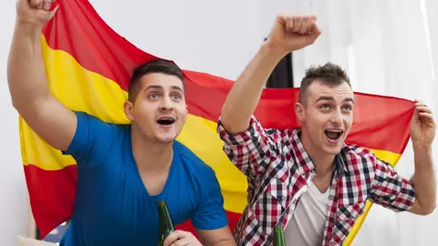 Men watching football match on TV and cheering of spanish team 